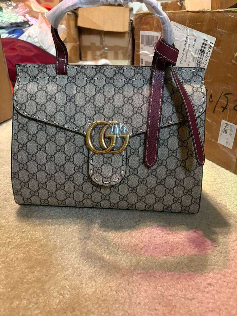 iconic GG Supreme canvas with red trim