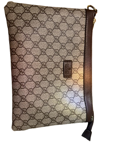 Gucci’s signature GG Supreme canvas - GG Supreme Pouch